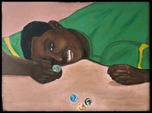 Young child resting with bright green clothing and a thoughtful expression.