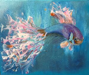 Vibrant blue and purple betta fish swimming through colorful flowing fins.